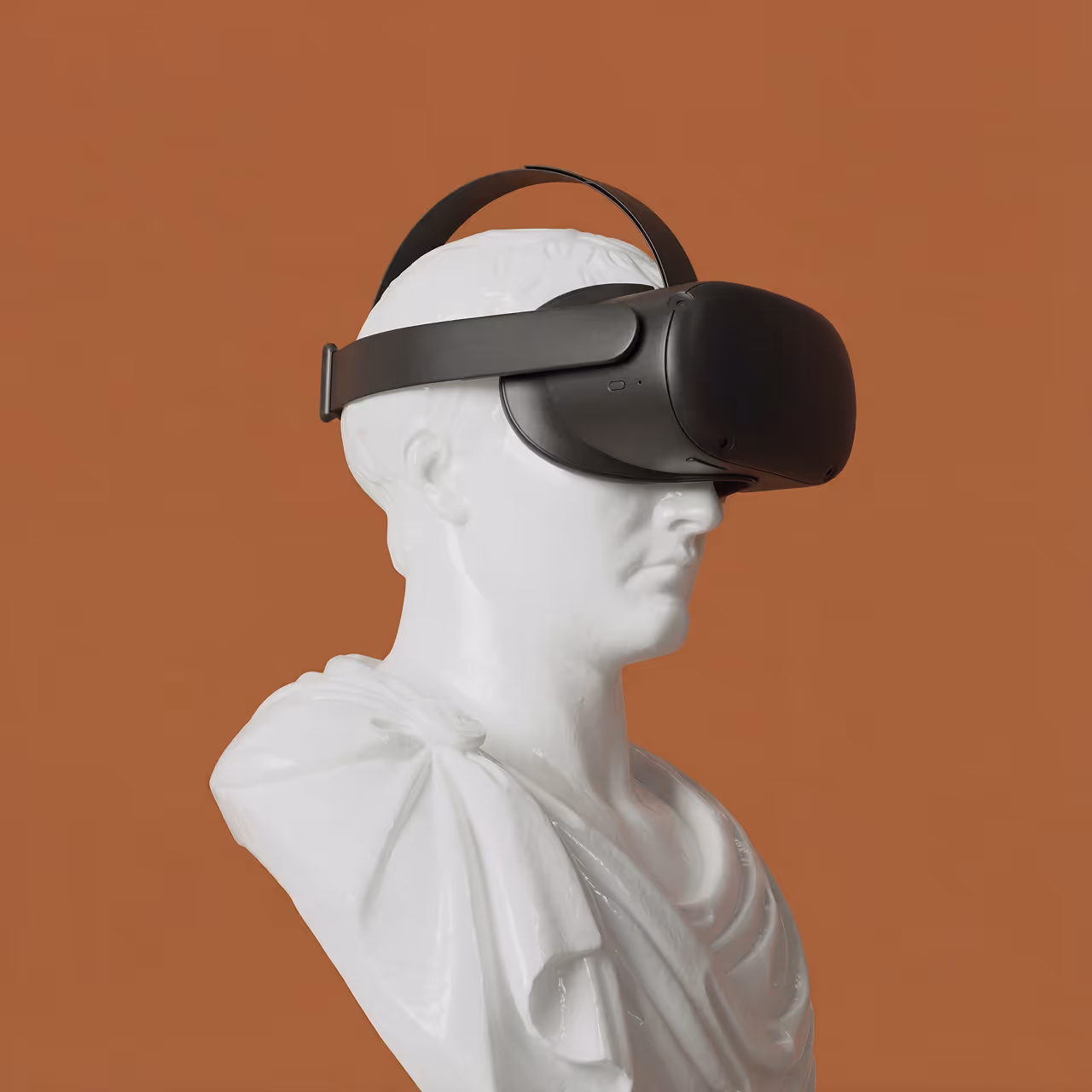 Classical white bust wearing a black VR headset against a brown background, blending tradition with modern technology.