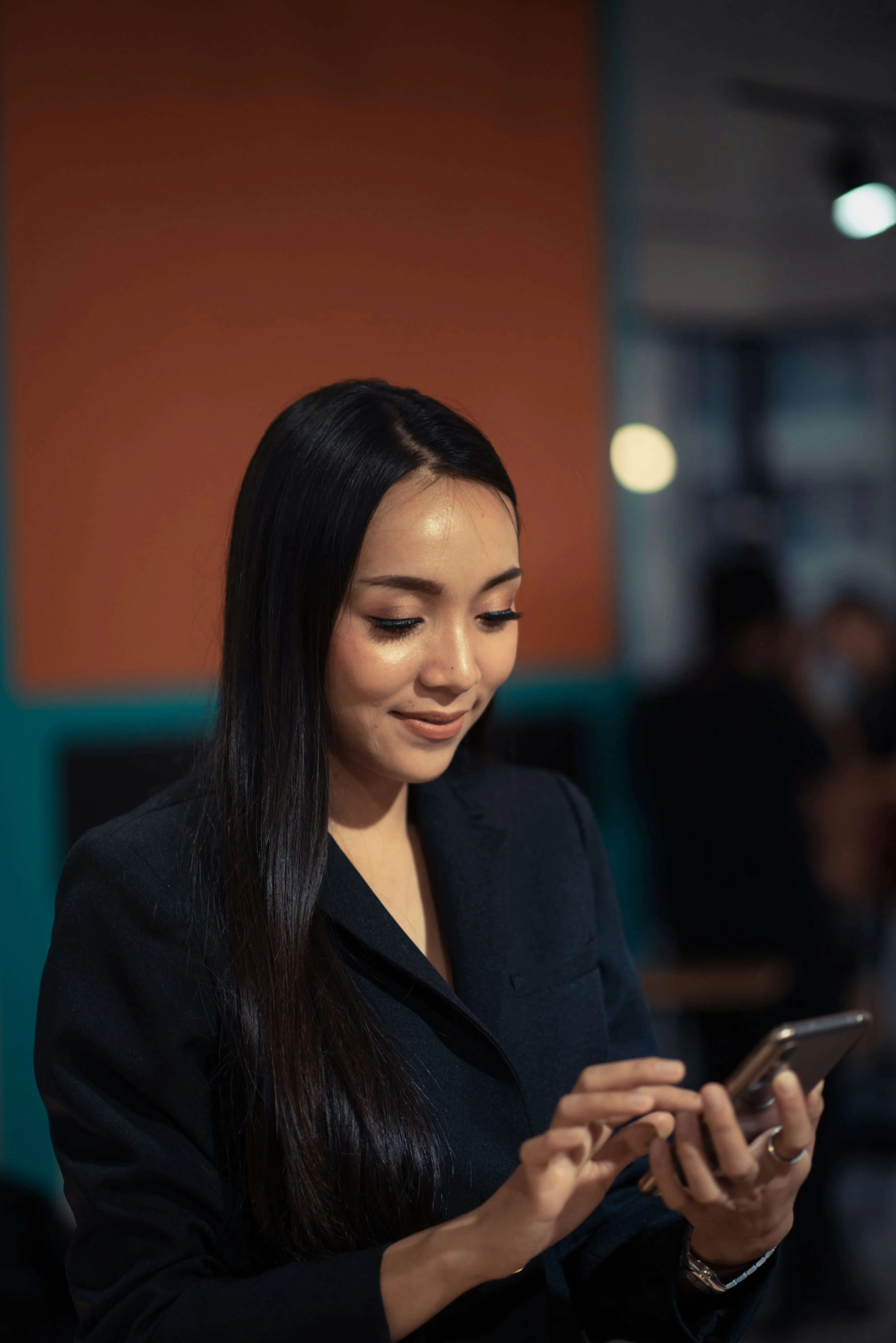 An image of a woman looking at her phone.